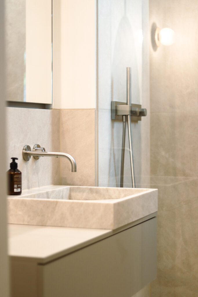 Bad mit hochwertigen Naturstein und maßgefertigten Einbauschränken